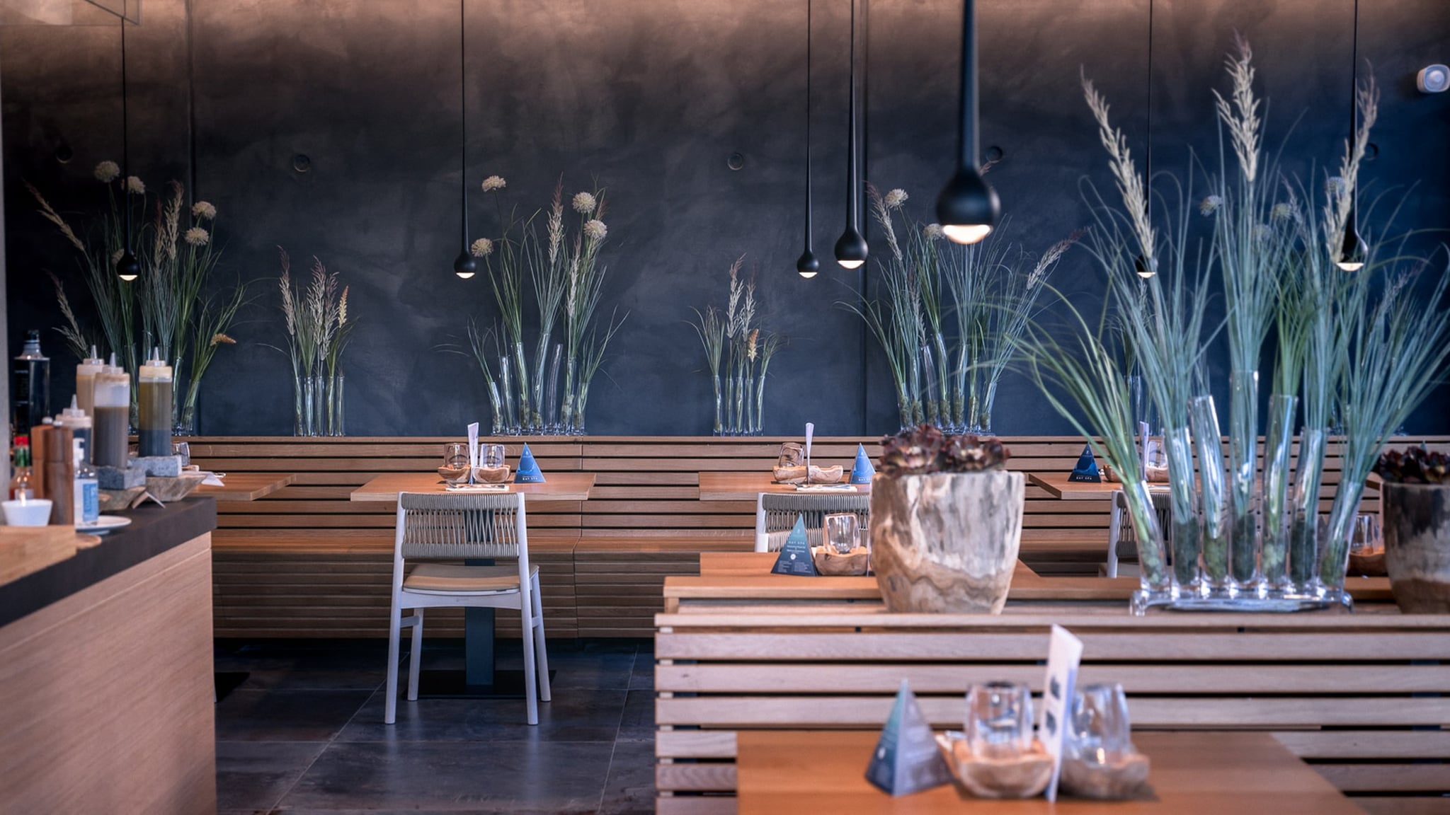 Salle de restaurant moderne avec décoration végétale.